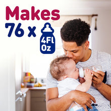 [42732562546869]Man holding a baby and feeding them from a bottle with text indicating quantity on a kitchen background
