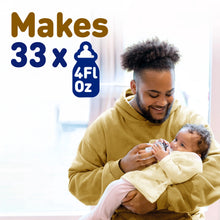 [49668523658]Man holding a baby and a bottle with text indicating product capacity