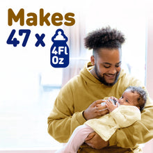 [8142192115818]Man holding a baby and a bottle with text indicating capacity, set against a blurred indoor background.