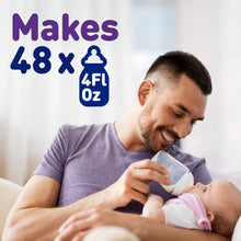 [2530576269322]Man feeding a baby with a bottle, with text indicating the bottle's capacity.
