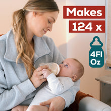 [49668588362]Woman holding a baby and feeding them from a bottle with text indicating bottle capacity.