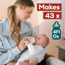 [12478728208495]Woman holding a baby and feeding them from a bottle with text indicating bottle capacity.