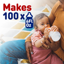 [42252316180661]Person holding a baby and a bottle with text indicating product capacity, on a patterned surface.
