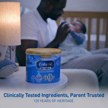 Enfamil Optimum formula container with a parent and child in the background